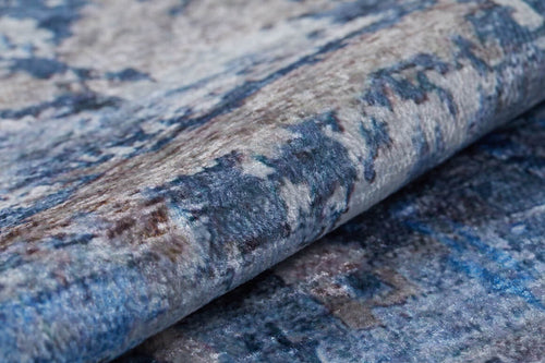 Load image 1 in gallery view. A close-up of the Enigmatic Elegance - Washable Rug - JR787, showing its blue, grey, and brown abstract pattern with a soft, textured surface—ideal for high-traffic areas.