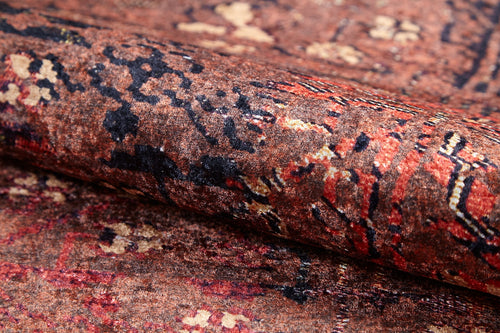 Load image 1 in gallery view. A close-up of the Ethereal Elegance - Washable Rug - JR1651 showcases intricate patterns in brown, red, black, and beige. This durable rug is ideal for high-traffic areas, highlighting the rich texture and detail of bronze and brown rugs.
