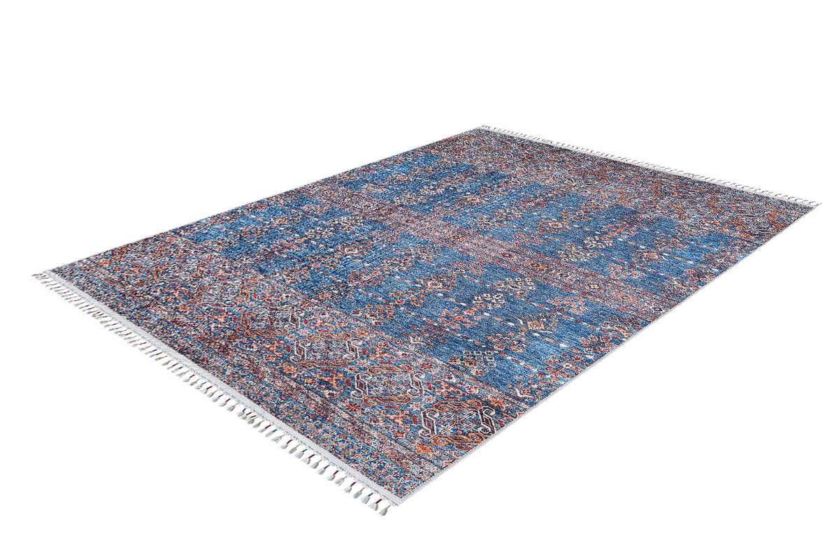 The Ethereal Essence - Washable Rug - JR5087 is a large rectangular blue rug featuring an intricate red and blue floral design, white fringed edges, and a subtly raised texture. Durable and elegant, it's shown on a white background.