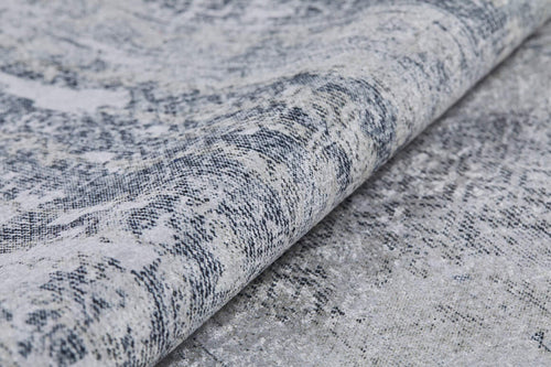 Load image 1 in gallery view. A close-up of the Faint Memories - Washable Rug - JR1437 highlights its dense woven fibers, abstract patterns, and a durable gray and off-white surface in textured gray-anthracite tones.