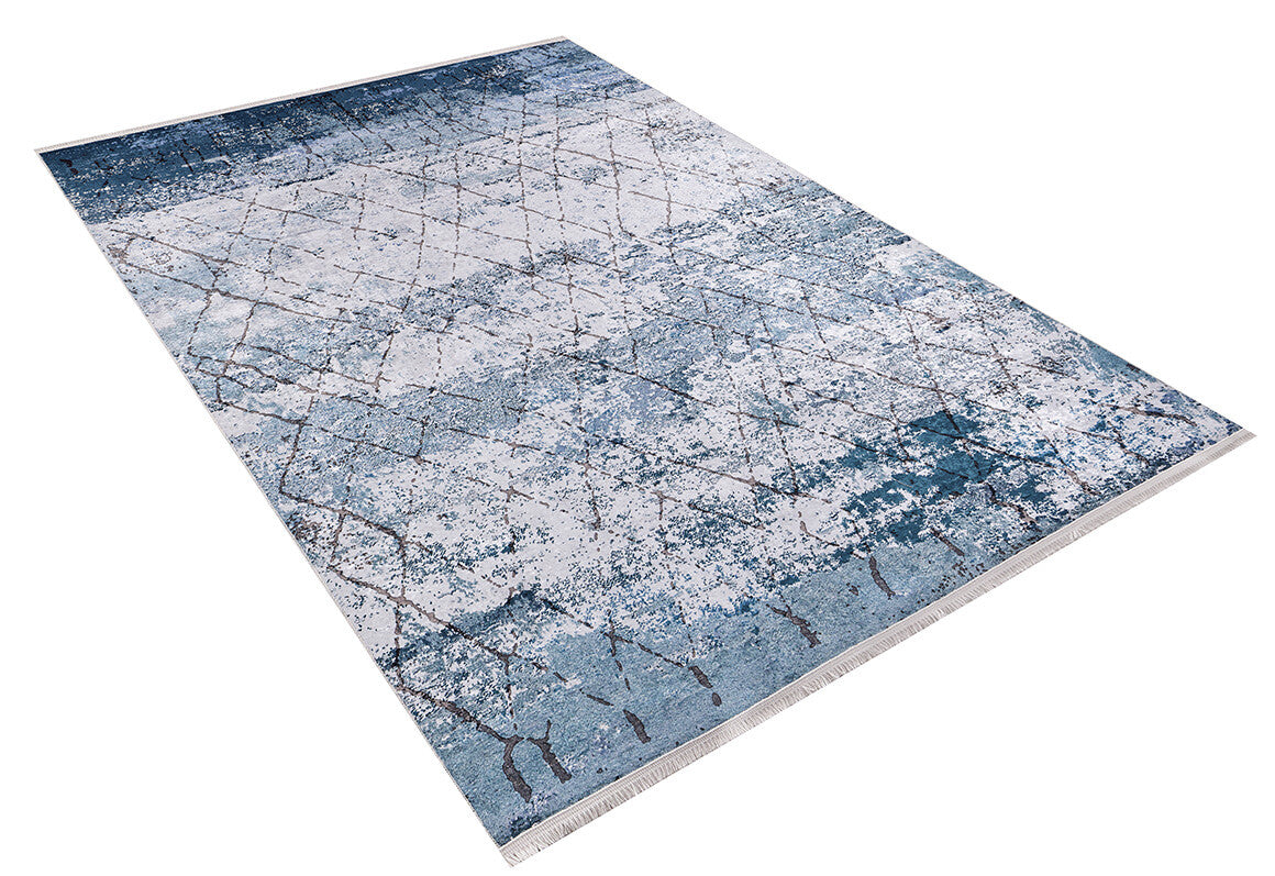 The Geometric Glimmers JR1423 is a rectangular washable rug with a modern blue, gray, and white abstract design of intersecting lines and a distressed texture—ideal for high-traffic areas.