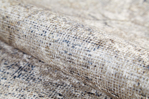Load image 1 in gallery view. Close-up of the Graceful Tapestry - Washable Rug (JR1975), a rolled flat weave with a mottled beige, cream, and brown pattern, small black speckles, and a subtly shiny finish.