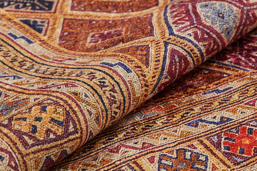Load image 1 in gallery view. A close-up of the Grandiose Grace - Washable Rug - JR44, featuring intricate geometric patterns in red, yellow, blue, and brown. Its detailed texture and washable design make it ideal for high-traffic areas.