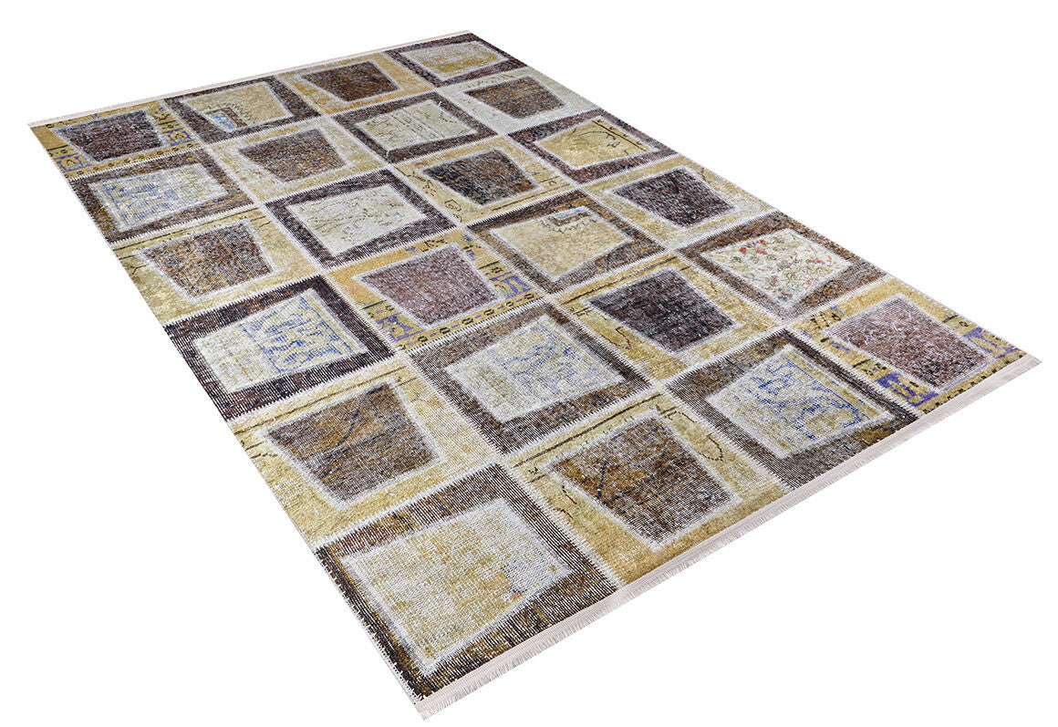The Gridiron Glow - Washable Rug - JR183 features a rectangular patchwork design in brown, beige, yellow, and cream tones. Perfect for high-traffic areas, this stylish rug adds a bronze and brown look to any space.