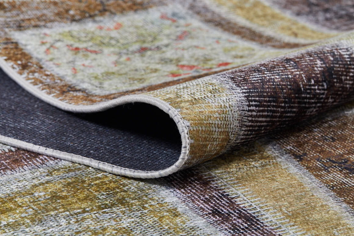 A close-up of the Gridiron Glow - Washable Rug - JR183 with one corner lifted, highlighting its detailed stitching and textured multicolored design—ideal for high-traffic areas.