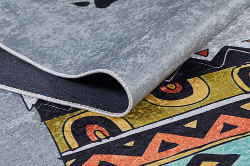 Load image 1 in gallery view. A close-up of the Groovy Bear - Machine-Washable Rug JRC093 in gray-anthracite shows a folded edge and bold geometric shapes in yellow, orange, black, and teal—ideal for adding style to high-traffic areas.