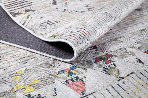 Load image 1 in gallery view. The Gypsy Glam - Washable Rug - JR1716 features colorful geometric patterns and detailed edge stitching, with its dark, textured underside partially visible—ideal for high-traffic areas and easy to clean.