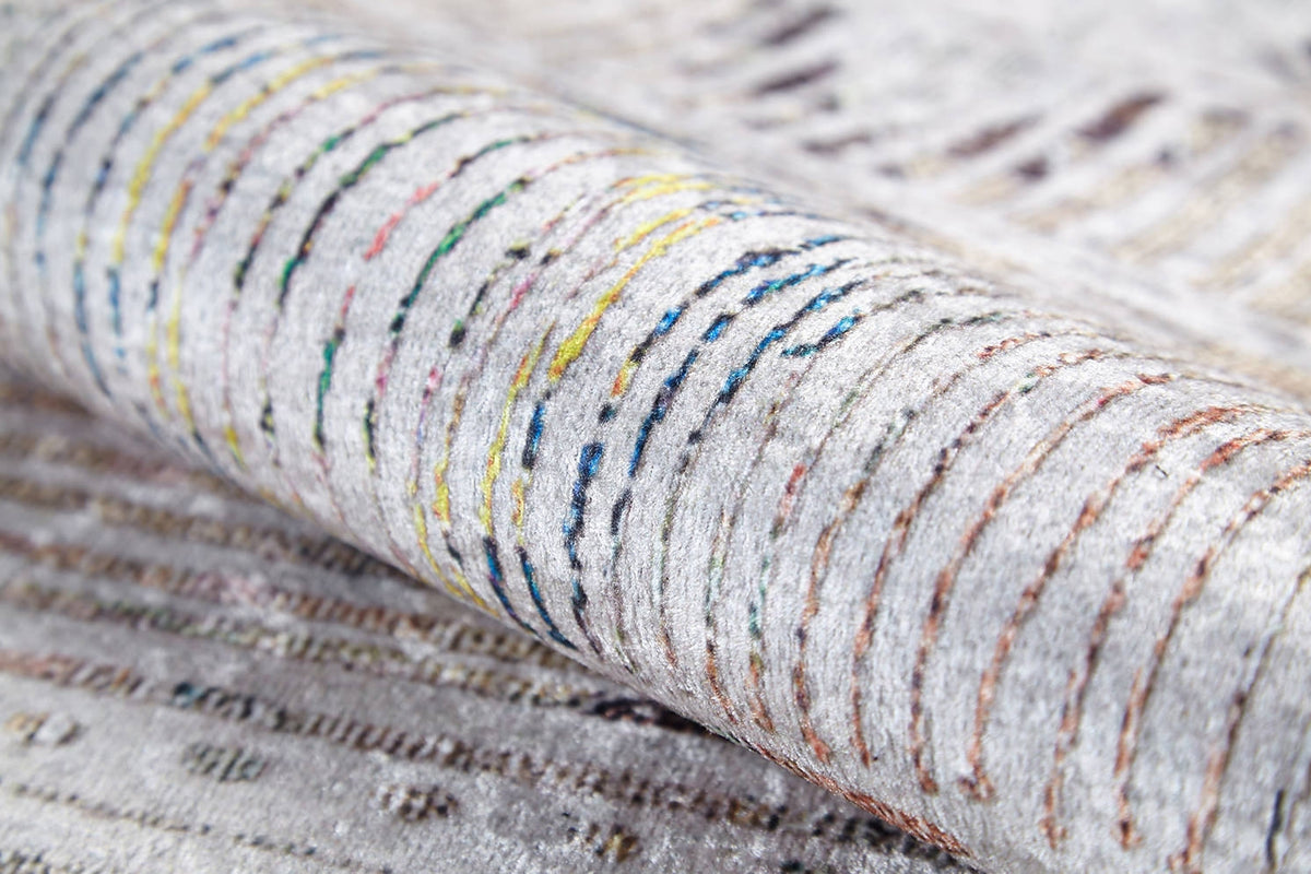 A close-up of the Gypsy Glam - Washable Rug (JR1716) shows its soft, textured surface with curved, multicolored lines on a light background—ideal for high-traffic spaces.