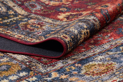 Load image 1 in gallery view. A close-up of the Historic Hues - Washable Rug - JR898 (Outlet) US, folded to display intricate blue, yellow, and cream floral and geometric patterns—making it a stylish, durable choice for high-traffic areas.