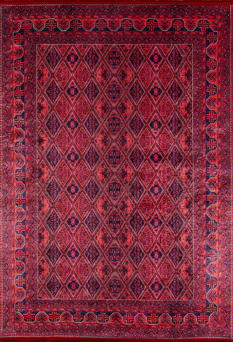 The Imperial Impressions - Washable Rug - JR1132 is a large, rectangular red rug featuring repeating diamond patterns and dark blue geometric motifs with a detailed red and blue border—ideal for high-traffic areas.