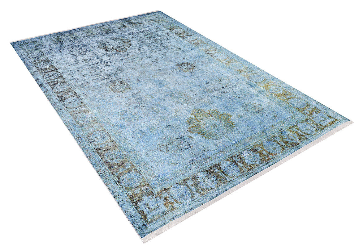 The Imperial Jewel - Washable Rug - JR162 is a large, rectangular blue rug featuring a faded vintage pattern and decorative border, ideal for high-traffic areas. Displayed at an angle on a white background.