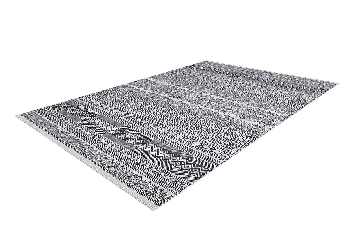 The Indie Impressions - Washable Rug - JR1648 is a rectangular gray-anthracite rug with black and white geometric and tribal patterns in horizontal stripes. Durable and washable, it’s perfect for high-traffic areas, shown on a white background.