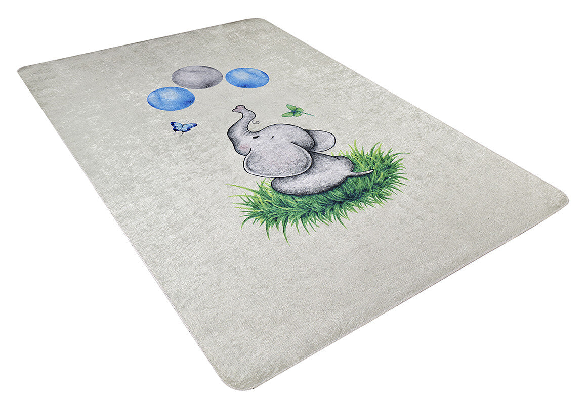 The Joyful Elephant - Machine-Washable Rug JRC026 is a light-colored rectangular rug showing a gray elephant on green grass looking up at blue bubbles, with a butterfly and green insect nearby.