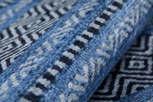 Load image 1 in gallery view. Close-up of the Layered Lines - Washable Rug (JR1545) in blue and white, featuring intricate geometric and zigzag patterns—highlighting its texture and durable weave, perfect for high-traffic areas.