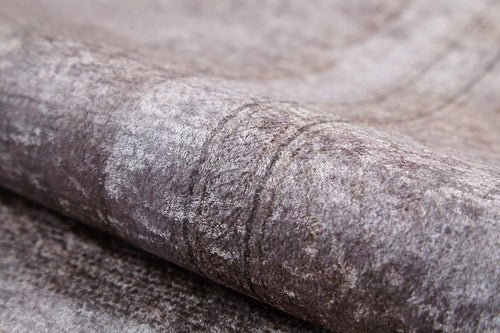 Load image 1 in gallery view. A close-up of the Luxe Borderline - Washable Rug - JR1741 shows its textured, folded grey fabric with subtle patterns and a soft, velvety feel—ideal for washable rug designs in high-traffic areas.