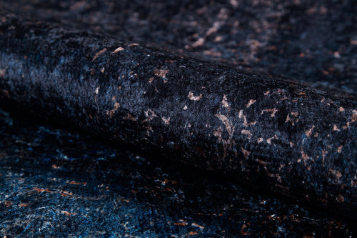 Load image 1 in gallery view. A close-up of the Luxurious Fleur - Washable Rug (JR1897) reveals a dark, textured surface with blue and brown shades, a rolled edge, subtle sheen, and speckled look—ideal for high-traffic areas.