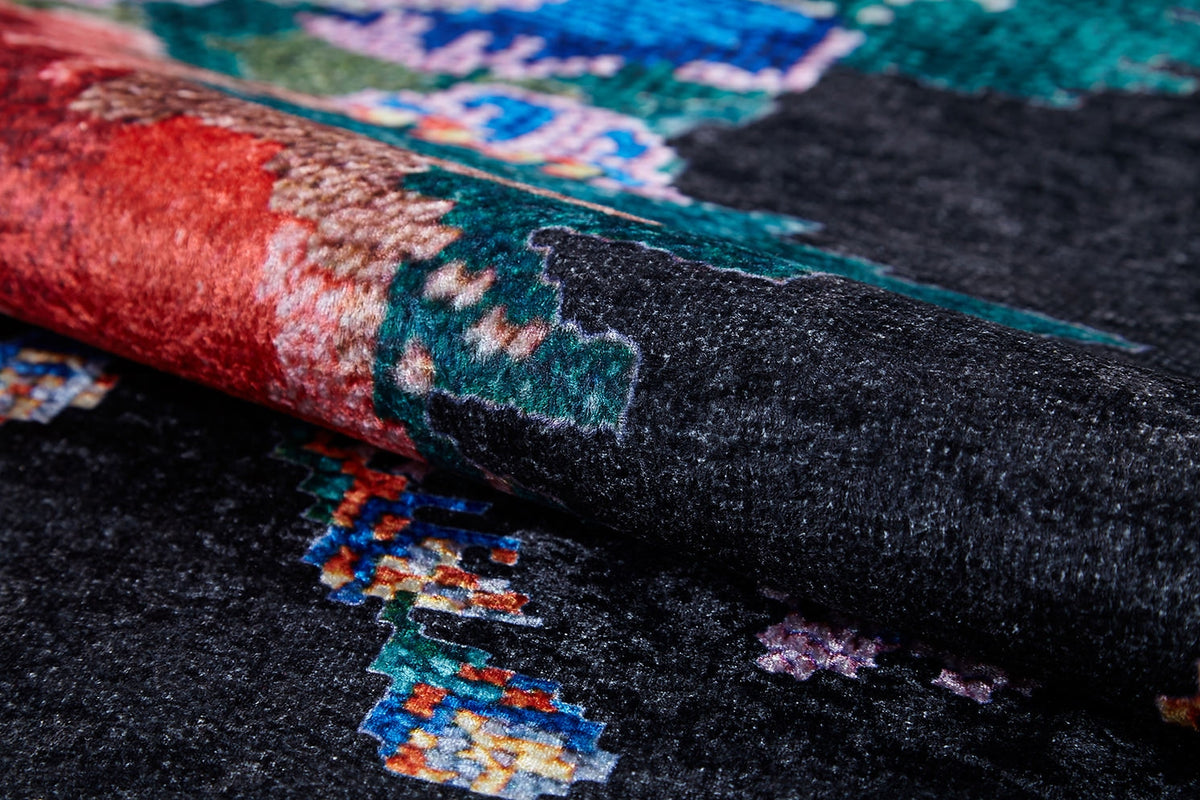 A close-up of the Meadow Dream - Washable Rug - JR2001 shows its dark, black background with intricate red, green, blue, and beige patterns. The woven texture is visible and the rug is washable—ideal for high-traffic areas.