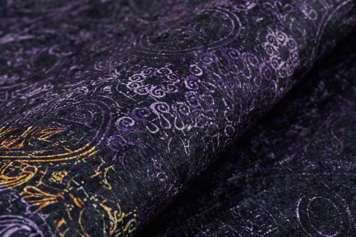 Bild 1 in Galerieansicht laden. A close-up of the Minimalist and Elegant - Washable Rug - JR1298 shows a dark, textured surface with purple swirling patterns and gold accents, offering an ornate design that's decorative and ideal for high-traffic areas.