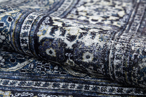 Load image 1 in gallery view. A close-up of the Opulent Beauty - Washable Rug - JR1932 reveals its ornate blue and white floral and geometric patterns—durable and perfect for high-traffic areas.
