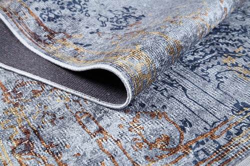 Bild 1 in Galerieansicht laden. A close-up of the Oriental Treasures - Machine-Washable Rug JR1613 in gray, blue, and gold, with a folded corner showing its texture and underside—an ideal choice for high-traffic spaces.