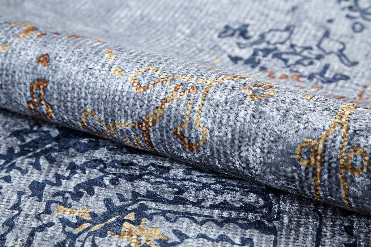 Close-up of the Oriental Treasures - Machine-Washable Rug JR1613, featuring a soft, textured surface with abstract blue, yellow, and brown lines and shapes on gray—durable design perfect for high-traffic areas.