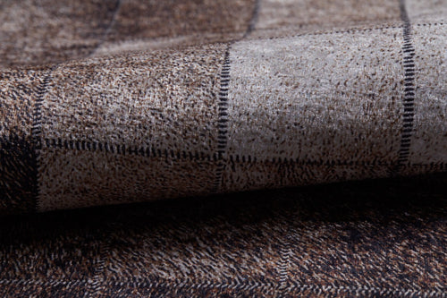 Load image 1 in gallery view. Close-up of the Pinstripe Paradise - Washable Rug (JR1004), showing folded flat weave fabric with brown, black, and gray plaid patterns, textured squares, and thin dark lines in a stylish washable rug design.