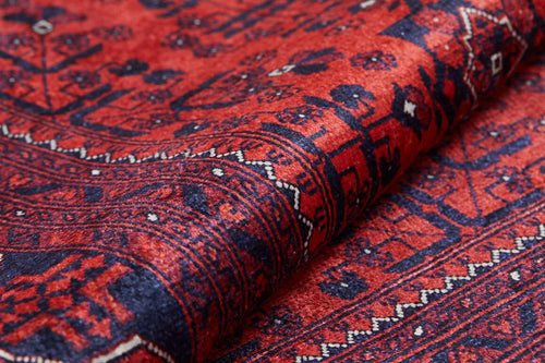 Load image 1 in gallery view. Close-up of the Regal Accents - Washable Rug - JR36: a traditional Persian-style red rug featuring intricate geometric patterns in deep red, dark blue, and black, detailed borders and motifs, with fabric slightly folded—ideal for high-traffic areas.
