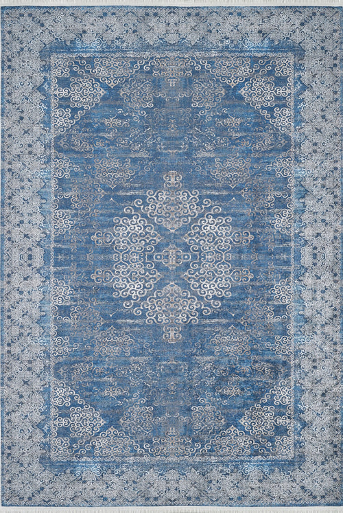 Load image 1 in gallery view. The Regal Insignia - Washable Rug - JR1786 is a rectangular blue rug with an ornate central medallion, swirling motifs, and a floral border. Its traditional design is stylish and practical for high-traffic areas, and it's easy to clean.