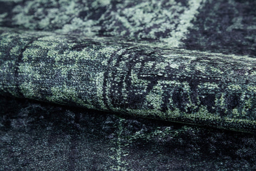 Load image 1 in gallery view. Close-up of the Rustic Remix - Washable Rug - JR1710, featuring a dark green and black intricate pattern and distressed vintage look—ideal for stylishly updating high-traffic spaces.