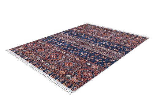 Bild 1 in Galerieansicht laden. The Sahara Sunrise - Washable Rug - JR5091 is a rectangular Persian-style rug with intricate red, blue, and white geometric patterns and fringed short edges. Perfect for high-traffic areas, it sits flat on a white background.