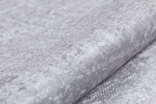 Load image 1 in gallery view. Close-up of Sea Spray - Washable Rug - JR847 in light gray, featuring textured velvet with a soft, subtly shiny surface—ideal for layering over cream, beige, or flat weave rugs to enhance cozy interiors.