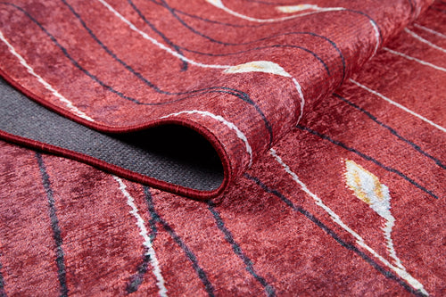 Bild 1 in Galerieansicht laden. A close-up of the Secret Garden - Washable Rug - JR1656 in red, featuring curved black lines and white and yellow leaf shapes, with a folded corner showing the underside—ideal for busy, high-traffic spaces.