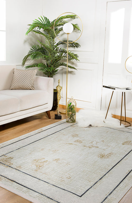 Load image 1 in gallery view. A modern living room featuring a light beige sofa, patterned pillow, potted plant, gold floor lamp, round side table, allergy-sensitive cream and beige rug, white and gold birdcage decor, and the Sleek and Contemporary - Washable Rug - JR1365 on wooden floors.