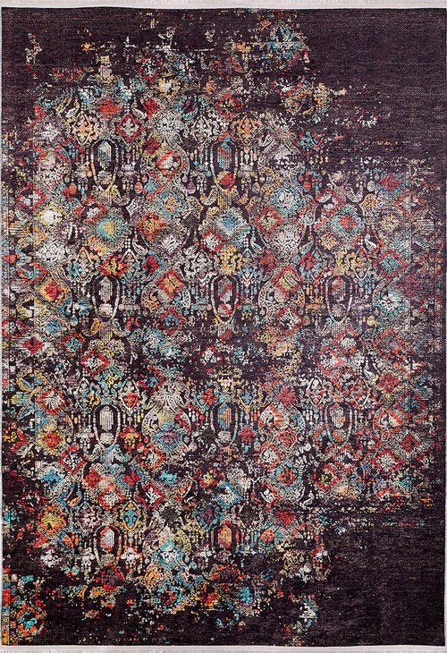 Bild 1 in Galerieansicht laden. The Soft Haze - Washable Rug - JR1094 is a rectangular rug with a distressed geometric pattern in vibrant red, blue, yellow, and white on a dark background, offering vintage style that’s both washable and allergy-friendly.