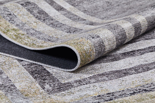 Load image 1 in gallery view. A close-up of the Sophisticated Trellis - Washable Rug (JR1194) shows its folded corner, revealing grey, black, white, and light yellow stripes and speckles—ideal for high-traffic areas. The edge and underside are also visible.