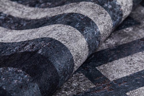 Load image 1 in gallery view. A close-up of the Sophisticated and Chic - Washable Rug - JR1409 shows its soft, slightly raised surface with textured, wavy horizontal stripes in various shades of gray and black.
