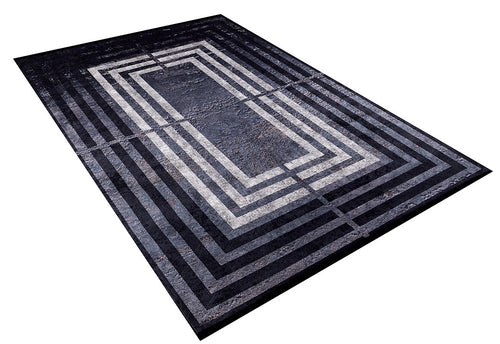 Load image 1 in gallery view. The Sophisticated and Chic - Washable Rug - JR1409 is a rectangular black rug with concentric rectangle patterns in black, gray, and white for an optical illusion effect. It has a flat weave and is shown angled on a white background.