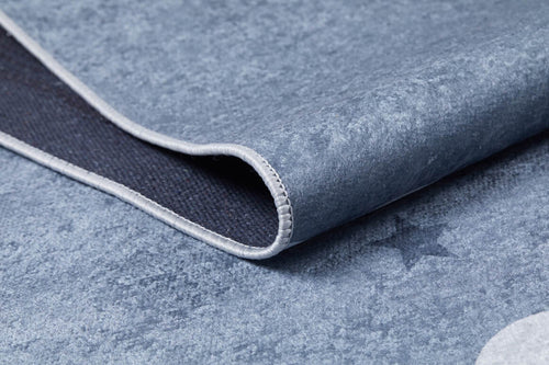 Load image 1 in gallery view. Close-up of the Starry Cloudscape - Machine-Washable Rug JRC045 in blue with light grey trim, slightly folded at the corner. A subtle star pattern decorates its textured surface.