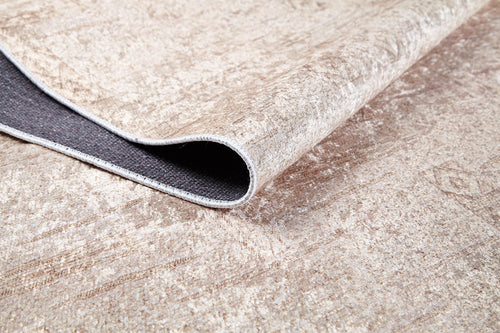 Load image 1 in gallery view. A close-up of the Sunset Fade - Washable Rug - JR1878 shows its beige textured surface, subtle pattern, and soft plush feel. One corner reveals the dark non-slip backing. Ideal for high-traffic areas and easy to wash.