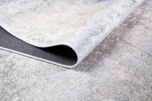 Load image 1 in gallery view. Close-up of the Sunset Sky Ombre - Washable Rug (JR1918) in light gray-anthracite, showcasing its marbled pattern, stitched border, and underside—perfect as a washable rug for high-traffic spaces.
