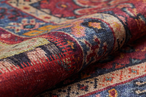 Bild 1 in Galerieansicht laden. Close-up of the Tapestry Tango - Washable Rug - JR313, a Persian-style rug with intricate red, blue, yellow, and cream patterns. Its detailed texture is clearly visible—ideal for high-traffic areas and easily washable.