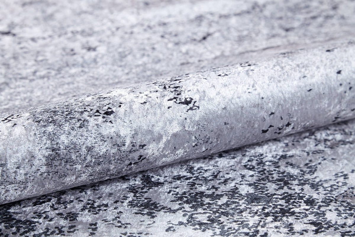 A close-up of textured wallpaper with a metallic silver-gray marbled design and black speckles, a reflective finish, and ideal for pairing with the Techno Flux - Washable Rug - JR1814 to enhance any modern space.