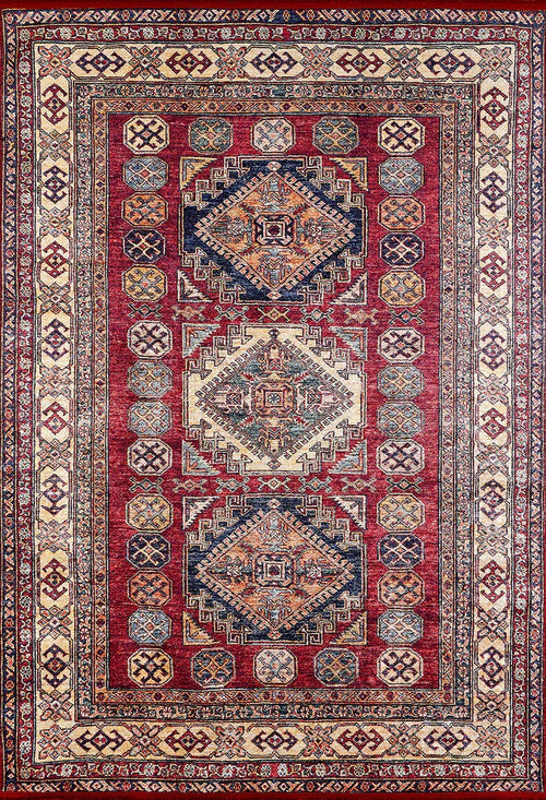 Load image 1 in gallery view. The Time-Honored Textures - Washable Rug - JR40 is a rectangular red rug with a rich background, geometric shapes, and detailed cream, blue, and gold borders. Its central diamond motifs and sturdy design make it ideal for high-traffic areas.
