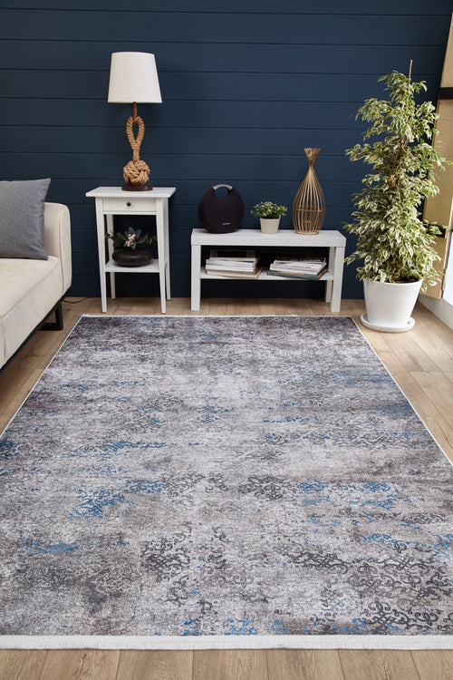 Load image 1 in gallery view. Modern living room with a Timeless Embellishment - Washable Rug - JR1943 in gray, white side tables, lamp, decor, books, potted plant, beige sofa, and navy blue accent wall.