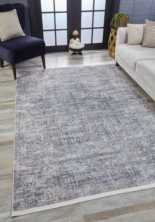 Load image 1 in gallery view. A modern living room features the Timeless Scrollwork - Washable Rug - JR1774 in light blue and gray-anthracite on wood floors, paired with a beige sofa and dark blue chair—ideal for high-traffic spaces with its washable design and large windowed doors behind.
