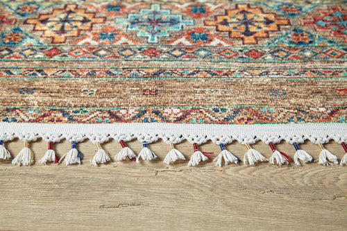 Load image 1 in gallery view. The Tribal Tango - Washable Rug - JR5089 features intricate geometric patterns in red, blue, and tan with a decorative white fringe accented in red and blue—ideal for high-traffic areas on light wood floors.