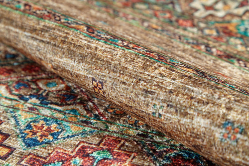 Load image 1 in gallery view. Close-up of the Tribal Tango - Washable Rug - JR5089, featuring intricate geometric and floral designs in bronze, brown, orange, blue, and green—perfect for high-traffic areas with its clearly visible texture and detail.