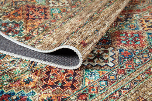 Load image 1 in gallery view. The Tribal Tango - Washable Rug - JR5089 features colorful geometric designs in red, orange, blue, and green. Shown with a folded corner revealing the gray underside and stitched edge, it's perfect for high-traffic areas.