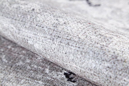 Load image 1 in gallery view. Close-up of the Tribal Tassel - Washable Rug - JR1683 in light gray, cream, and beige highlights its soft, plush feel and subtle speckled pattern. Slightly rolled or folded, this washable rug suits high-traffic areas perfectly.