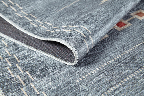 Load image 1 in gallery view. A close-up of the Tuscan Villa - Washable Rug - JR5058 in gray-anthracite with beige and red geometric patterns, highlighting detailed stitching and textured fabric on a folded corner—ideal for high-traffic areas.